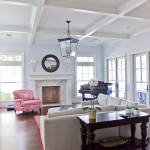Windows abound through this nautically themed living room—do you feel like you’re in Cape Cod yet? Note the herringbone pattern wood-burning fireplaces surrounded with marble and the French doors leading to the patio. The coffered ceilings finish the look, transporting you into 1700s New England.